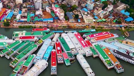 Dhaka,-Bangladesh---Ships-Moored-at-Sadarghat,-a-Bustling-River-Harbor-on-the-Buriganga-River---Aerial-Drone-Shot