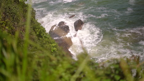 watching the waves crash into the rocky shoreline from the cliffs above the ocean