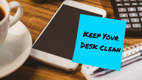 animation of keep your desk clean text on memo note over smartphone on desk