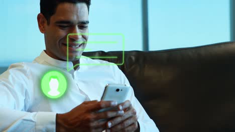 Animation-of-person-icon-and-speech-bubble-over-smiling-asian-man-using-smartphone