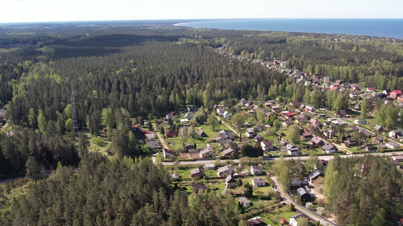 Aerial View of a Coastal Town Surrounded by Forest