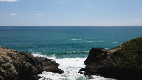 flying out from the beach through narrow cove towards the expansive tasman sea