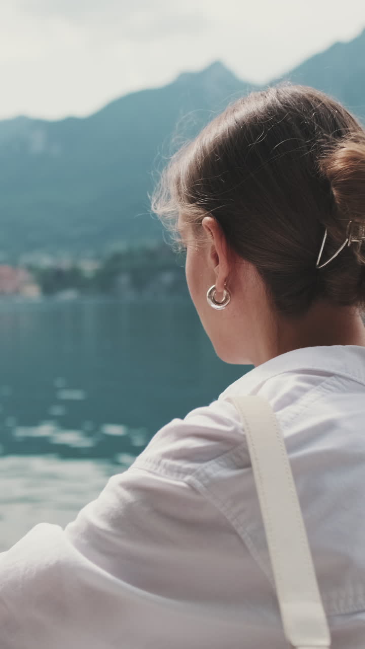 Young Woman Looking at Scenic Lake and Mountains