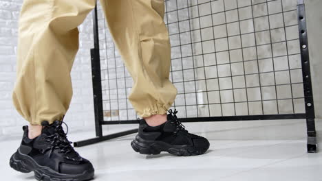 sports wear and footwear demonstration in the photo studio. black leather modern sneakers close up.
