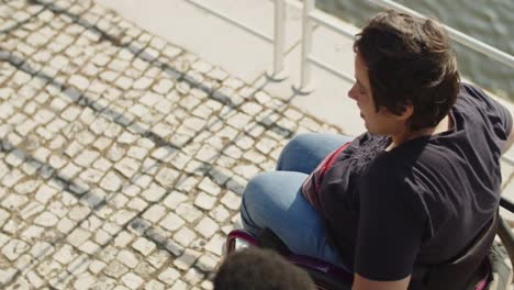 above view of woman using wheelchair talking to friend