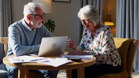 elderly couple managing home finances and paperwork