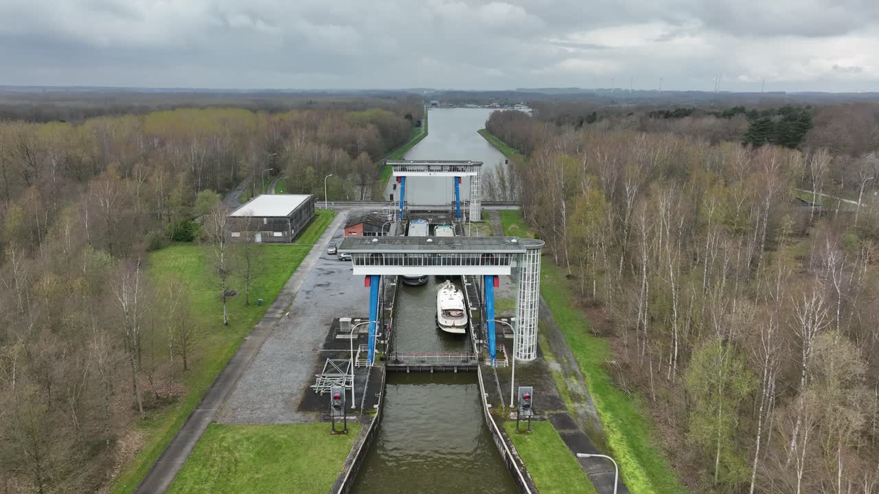 Zoom in over the Strépy-Thieu boat lift in Le Roeulx on a cloudy day, showing vessels inside the lift