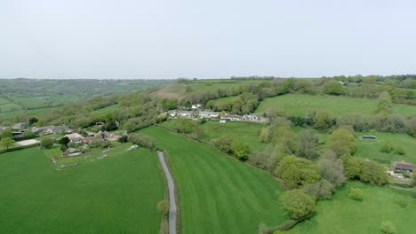 aerial moving forwards towards beautiful quaint english country village in the heart of devon