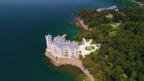 through the lens of a drone camera, one can behold the striking beauty of the miramare castle, proudly positioned against the seafront