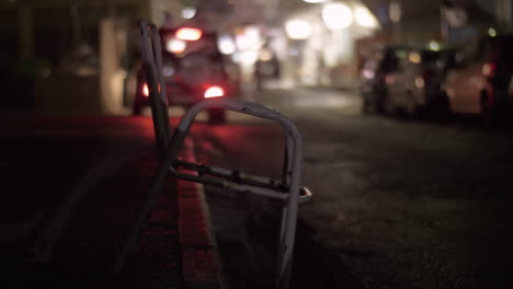 Street-in-town-at-night-Grungy-chair-in-foreground