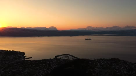 Aerial-view-of-sunset-over-city-by-the-ocean