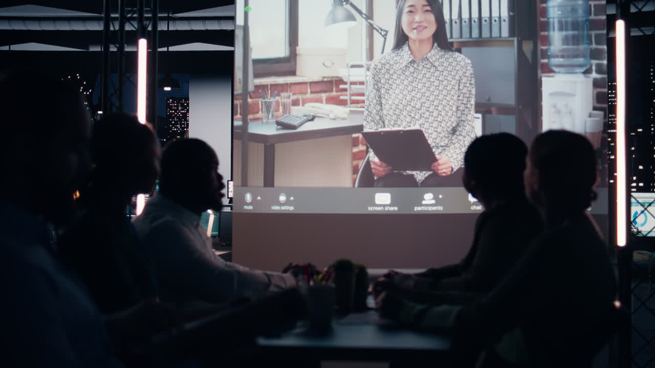 Coworkers participate in a late night digital meeting with general director