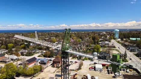 drone circling around a crane with a large lake in the background