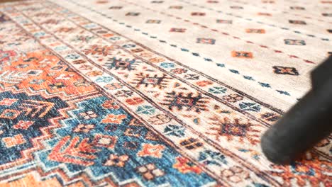 woman vacuuming a patterned rug