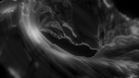 animation of glowing grey rotating wave on dark background