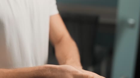 close-up-of-male-hands-rubbing-in-hands-and-palms