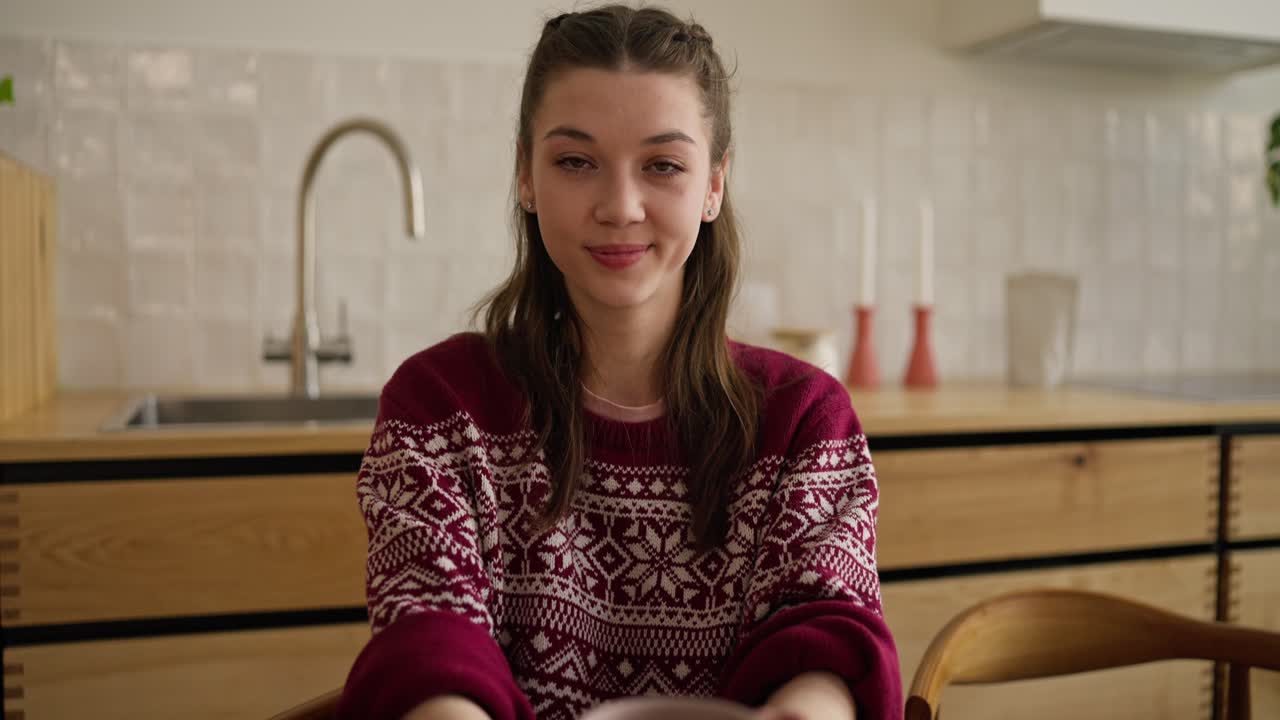 Young Woman in Cozy Sweater Holds Mug