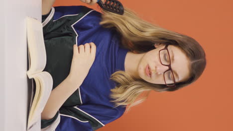 Vertical-video-of-Young-woman-combing-her-hair.