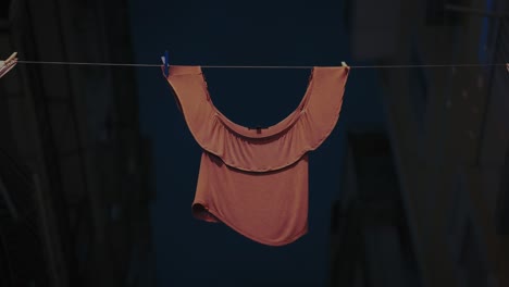 hanging shirt on urban clothesline. naples, italy