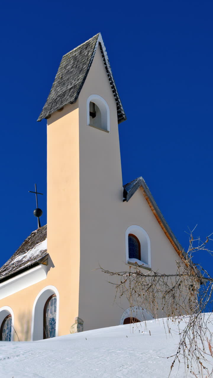 View of the Chapel of the Alpini at the Gardena Pass in the Dolomites, Italy with the blue sky on the background. Vertical