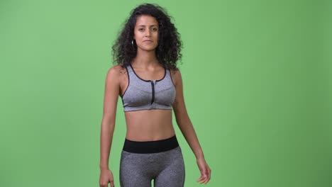 young beautiful hispanic woman stretching and ready for gym
