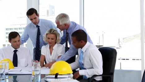 group of architects looking at plans