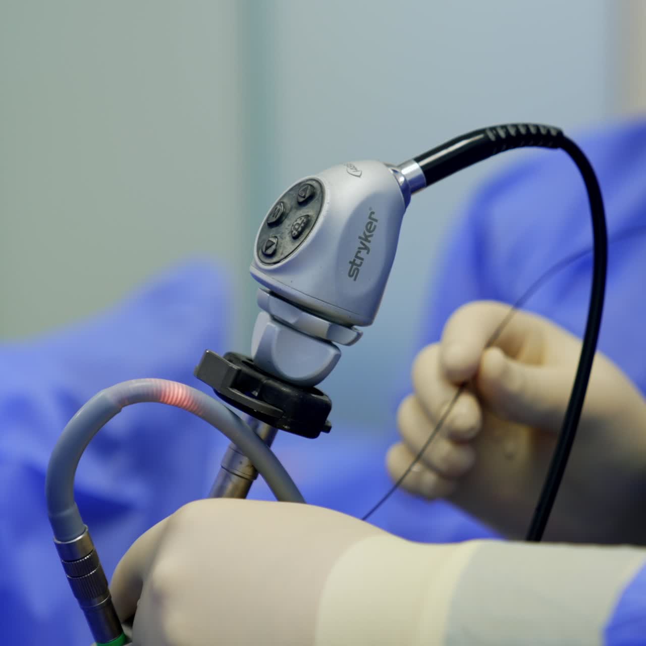 Medical equipment in surgical room. Doctor is using the operational device during the surgery. Close up. Blurred backdrop