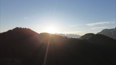 aerial drone orbit in austrian alps with sunny mountain range in background austria, europe