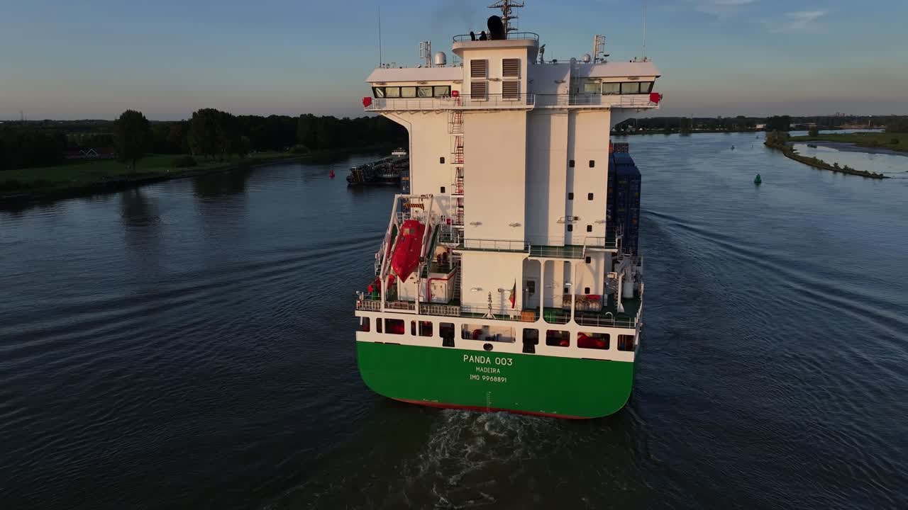 Large Container Ship 'PANDA 003' Navigating a Waterway