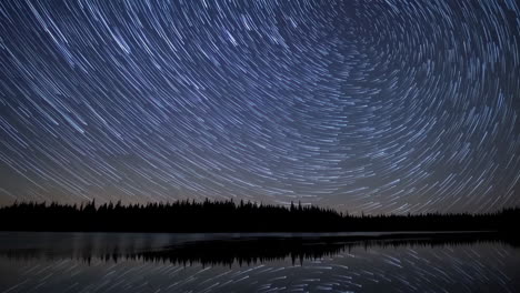 star trails over a calm lake