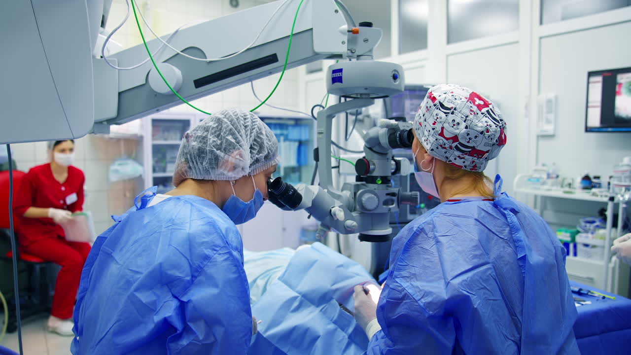 Surgeons holding medical instruments. Surgeon team in uniform in front of eye vision surgery operation room at medical clinic