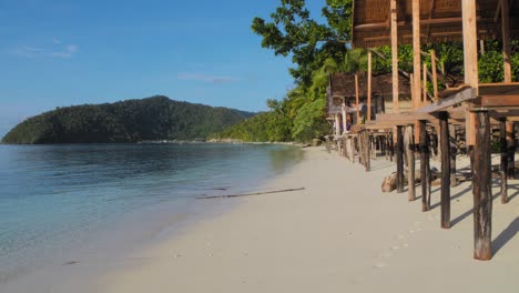 tropical beach paradise with stilt bungalows
