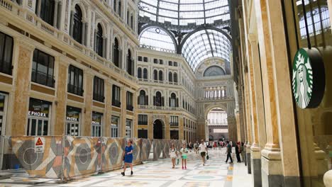 people walking inside historic shopping gallery