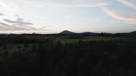 big-mountain-behind-a-forrest-on-sunset