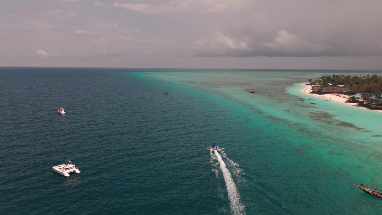 Aerial View Of Motorboat Cruising In The Ocean Along Nungwi, Zanzibar, Tanzania.