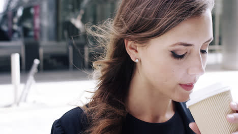 Attractive-business-woman-commuter-using-smartphone-in-city-of-london