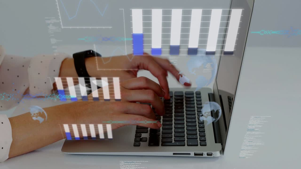 Mid-adult woman typing on silver laptop at desk in dotted top and smartwatch, showing data overlays