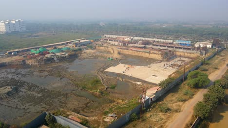 aerial drone shot of nimbus palm village capturing a massive construction site in sector 22a in greater noida, india