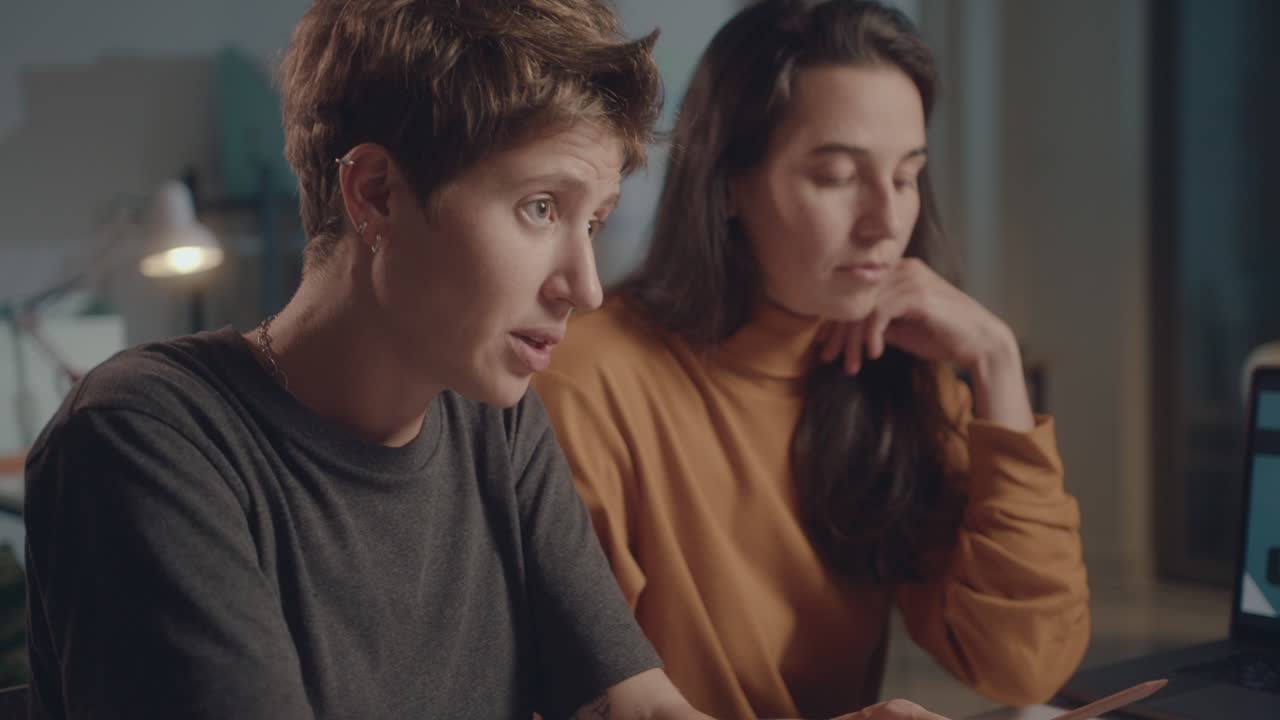 Colleagues Discussing Business Papers on Office Meeting during Night