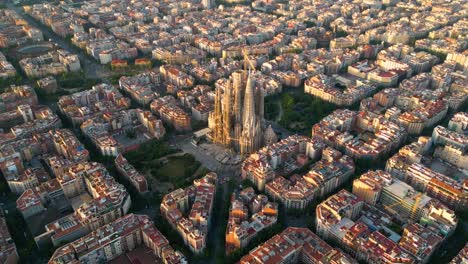 aerial view of barcelona eixample residential district and famous basilica sagrada familia at sunrise. catalonia, spain