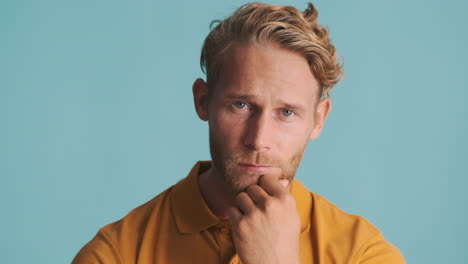 bearded blond guy touching his chin