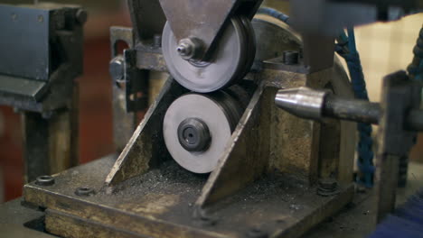 lathe machine processing metal shaft at metalworking factory