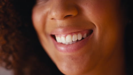 studio close up shot of laughing woman's mouth promoting body positivity