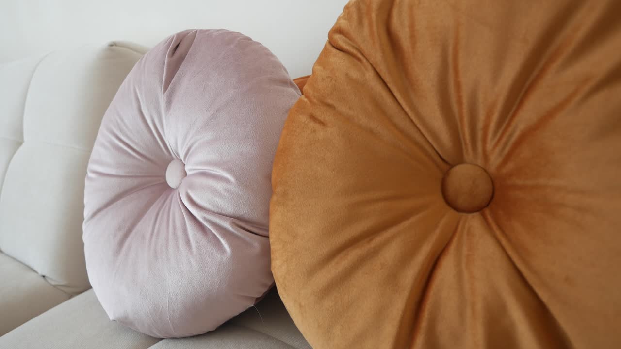 Two Round Velvet Pillows on a Sofa