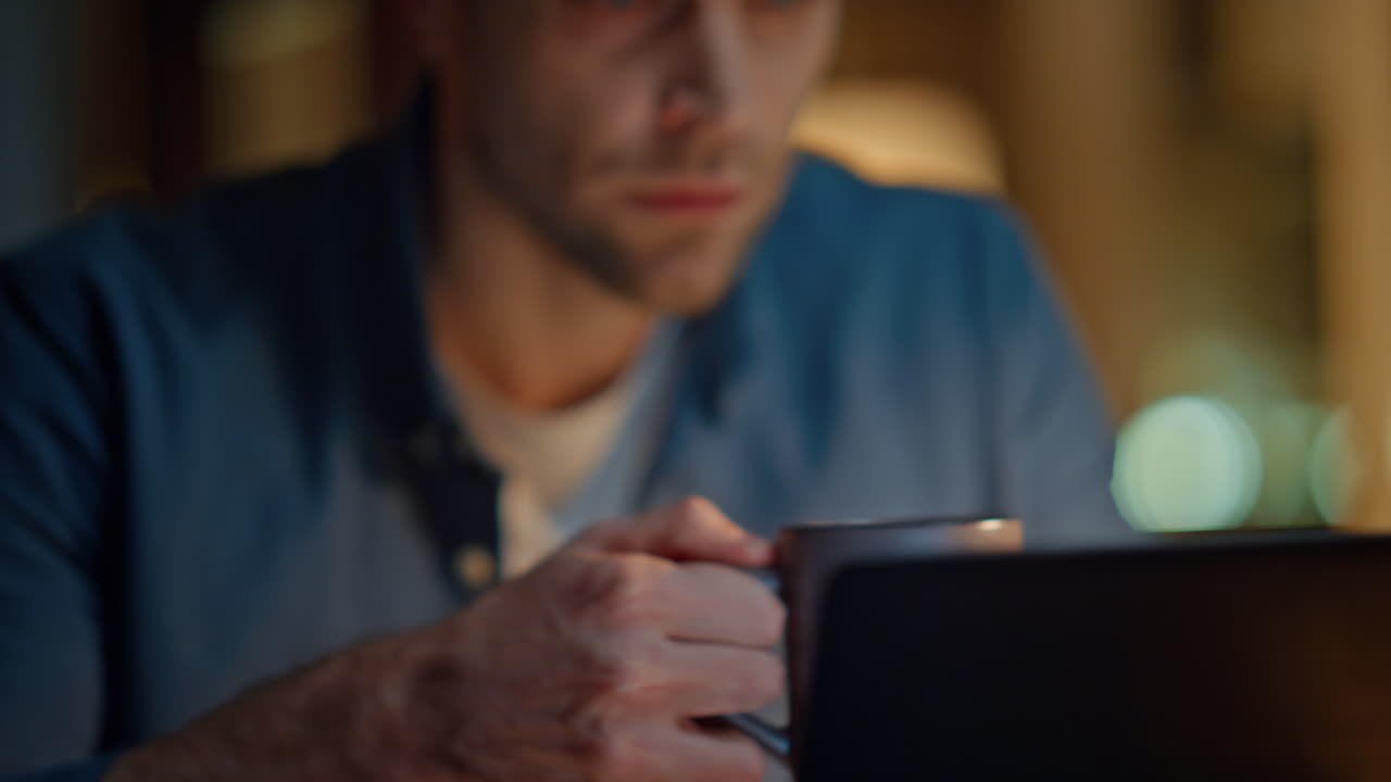 Man hands texting laptop keyboard at night office closeup. Businessman drinking