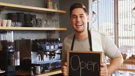 Happy-owner-with-chalkboard-at-counter