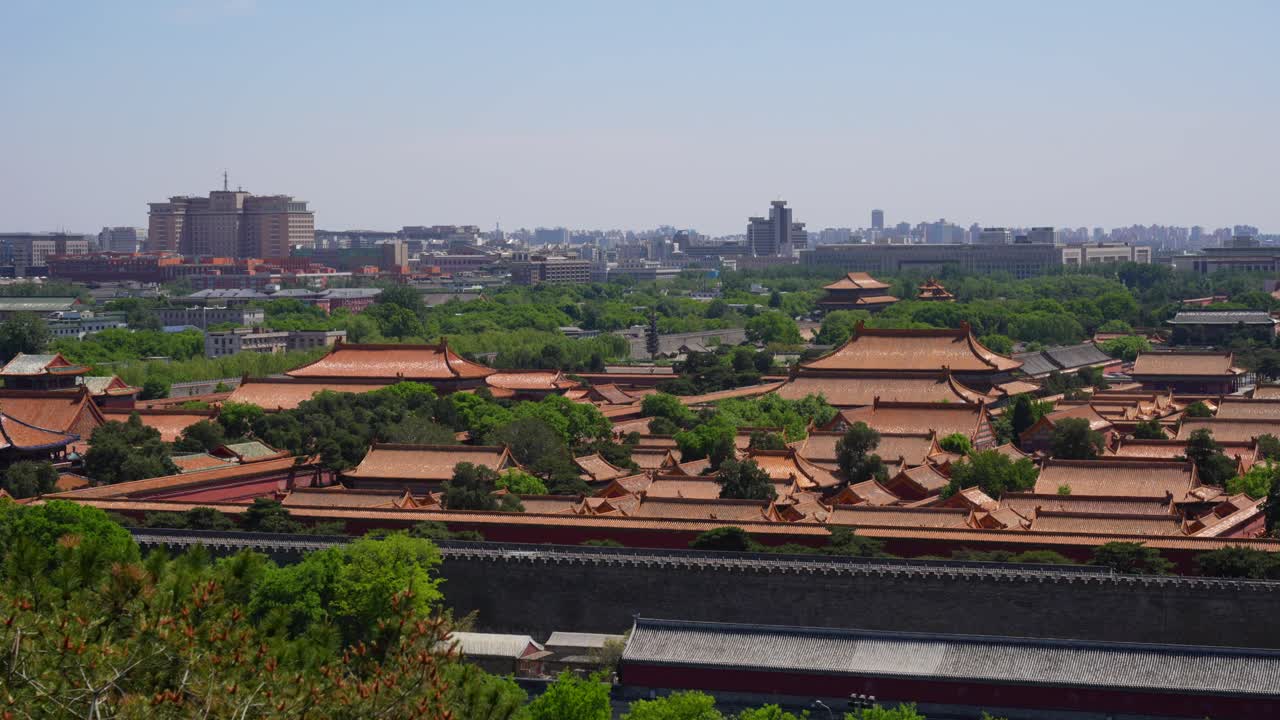 Ancient Forbidden City roof tops and modern Beijing in background, China