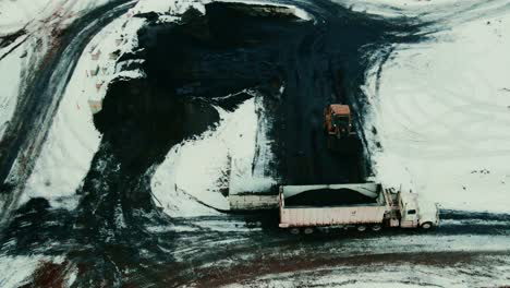 Efficient-black-dirt-handling-at-Canadian-sawmill-in-winter:-wheel-loader-loading-semi-truck