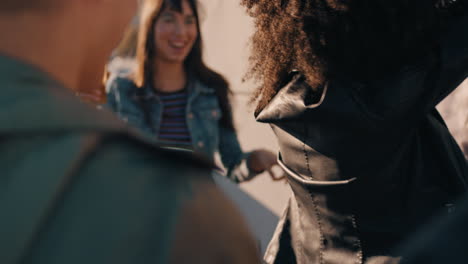 slow-motion-group-of-multiracial-friends-hanging-out-young-african-american-woman-dancing-enjoying-rooftop-party-at-sunset-drinking-alcohol-having-fun-on-weekend-celebration