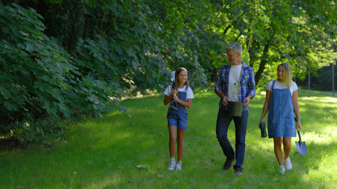 Family Planting a Tree in the Park